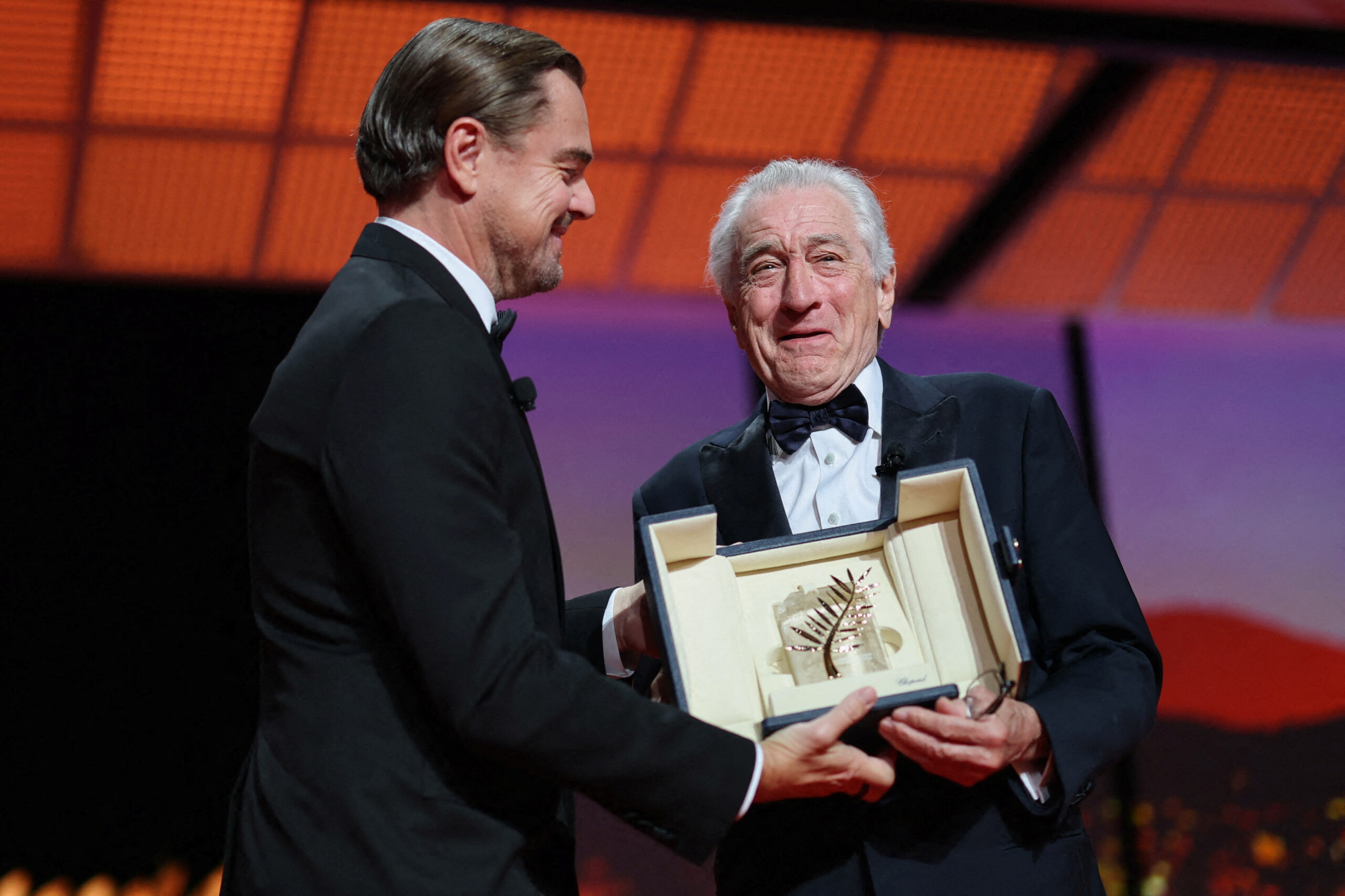 Robert De Niro receives an Honorary Palme d'Or Award from Leonardo DiCaprio during the opening ceremony and the screening the film "Partir un jour" (Leave One Day) Out of competition at the 78th Cannes Film Festival in Cannes, France, May 13, 2025. REUTERS/Stephane Mahe TPX IMAGES OF THE DAY